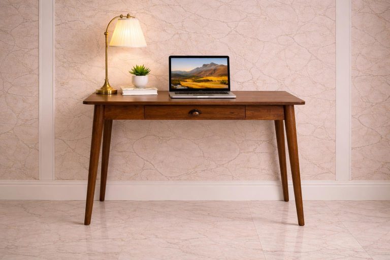 Wooden desk with laptop, lamp and plant