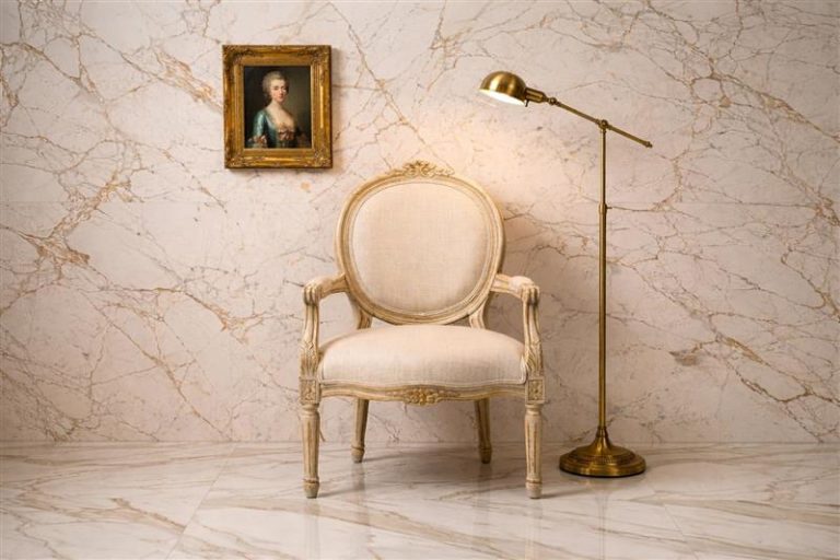 Classic armchair with brass lamp and portrait